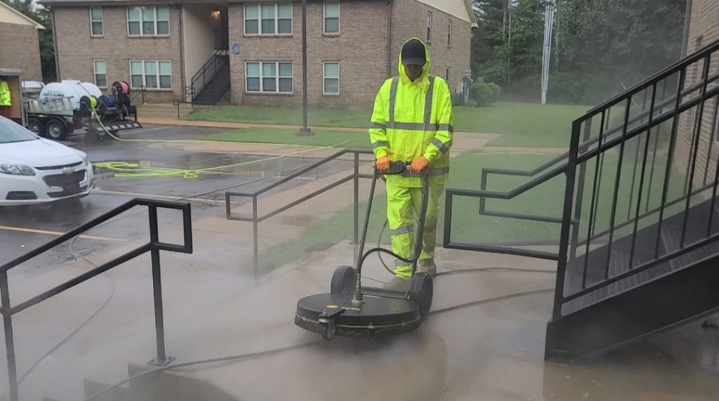 professional pressure washing an apartment complex
